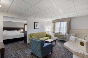 Suite, 1 King Bed, Non Smoking, Jetted Tub (with Sofabed) | Pillowtop beds, laptop workspace, blackout drapes, iron/ironing board