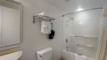 A modern bathroom with a toilet, a shower, and a sink.