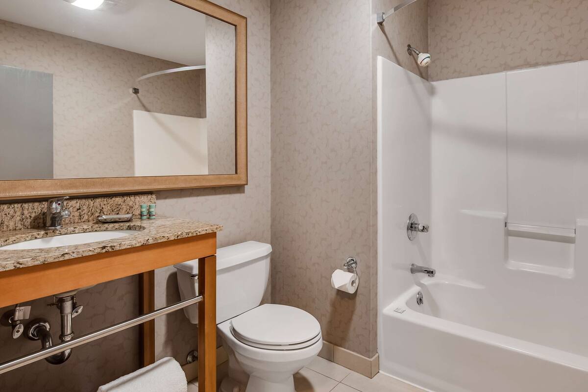 A bathroom with a sink, toilet, and bathtub.