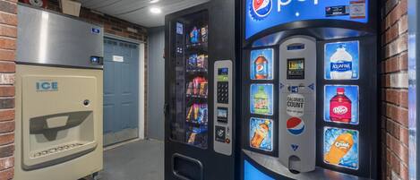 A vending machine with a Pepsi logo, a Coca-Cola machine, and an ice dispenser.