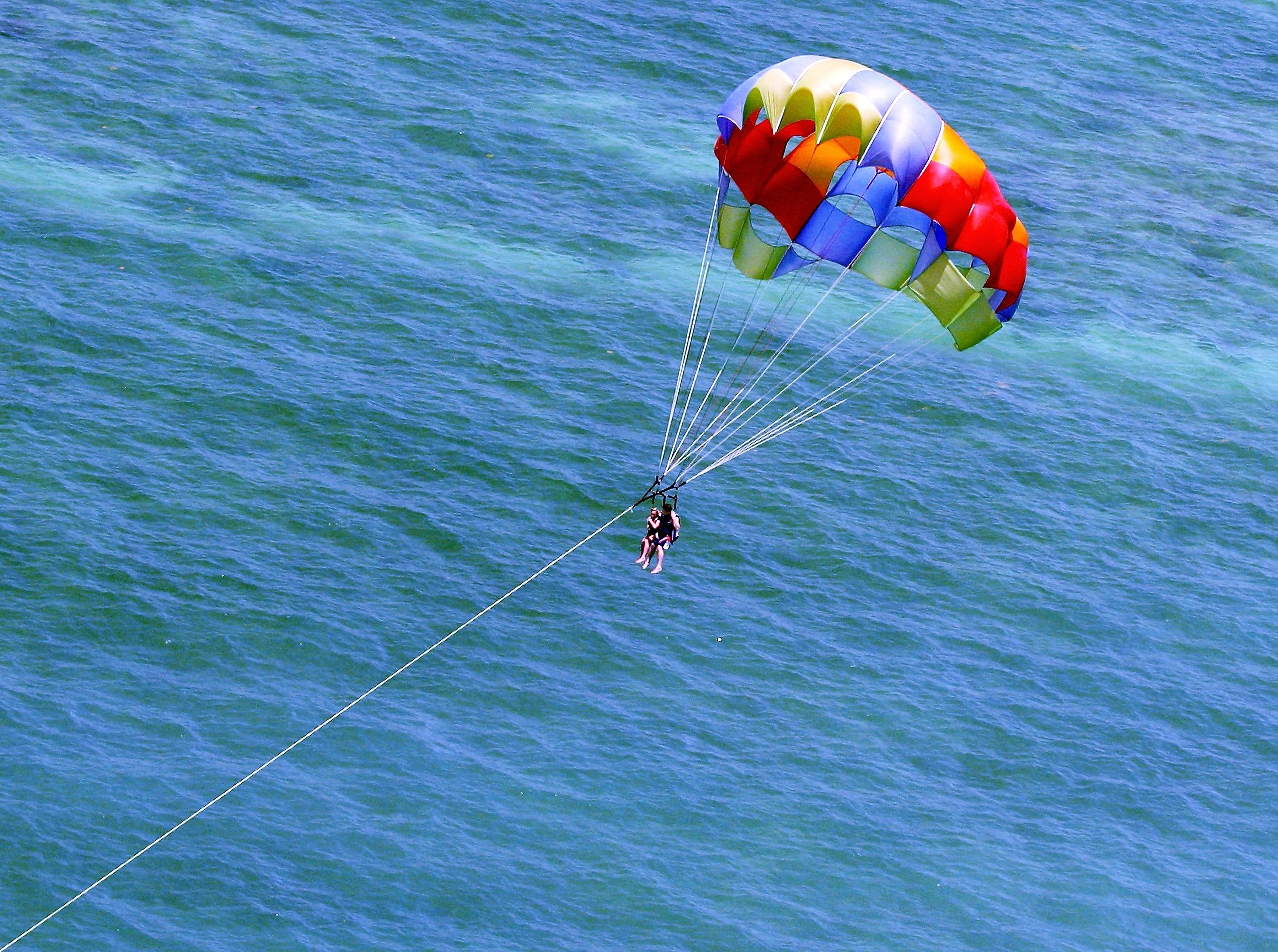 A person parasailing over a body of water.