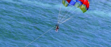 A person parasailing over a body of water.