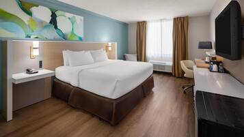 Hypo-allergenic bedding, desk, laptop workspace, blackout drapes