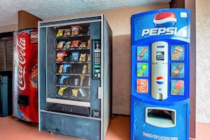 A vending machine with a Coca-Cola logo and a Pepsi machine with a blue color scheme. - Quality Inn & Suites Live Oak I-10 Exit 283 (Live Oak)