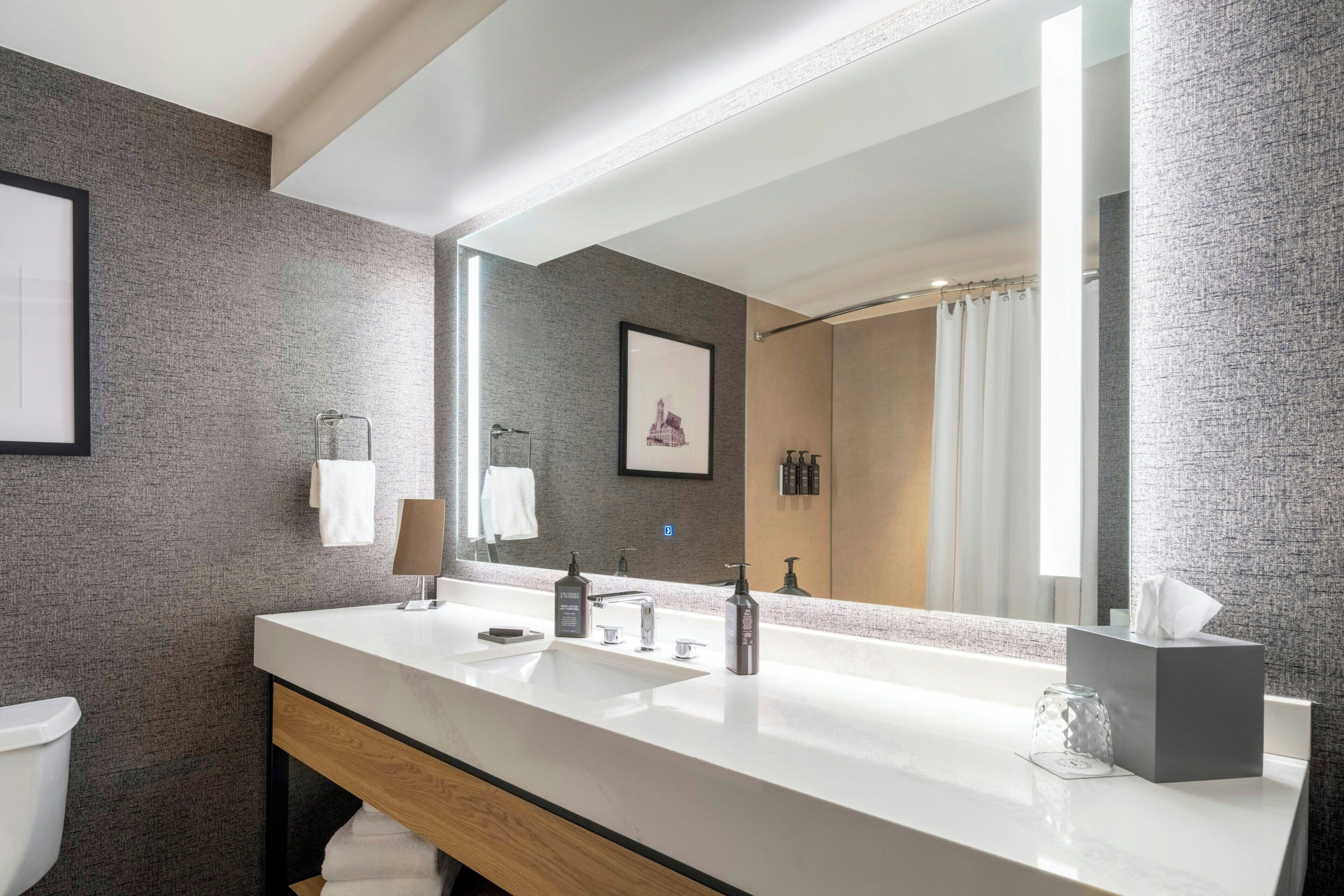 combined shower/bathtub, designer toiletries, hair dryer, towels