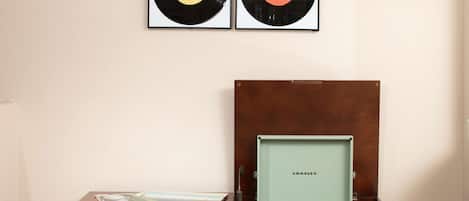 A wooden cabinet with a framed picture of a record on top.