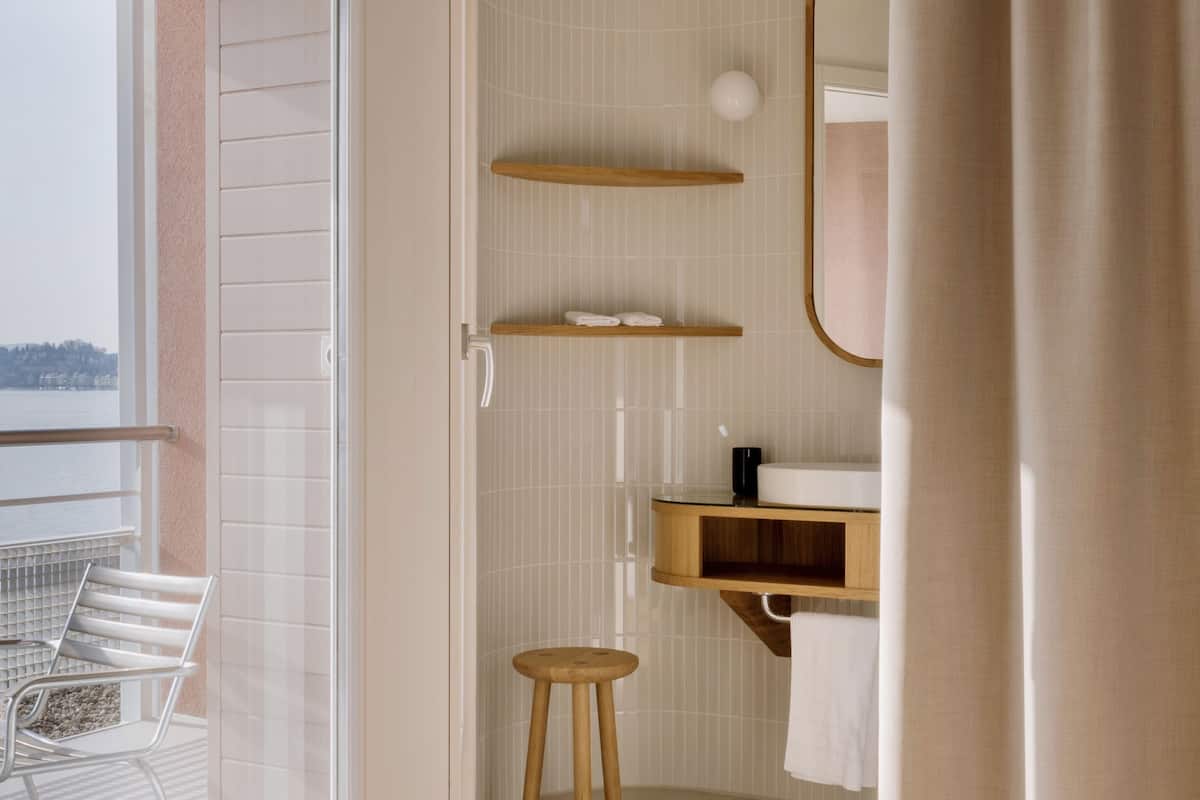 lake view design balcony room | bathroom | designer toiletries, hair dryer, bathrobes, slippers