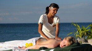 A massage therapy session on a beach with a clear view of the ocean. - Nakelo Treasure Island Resort & Spa (Treasure Island)