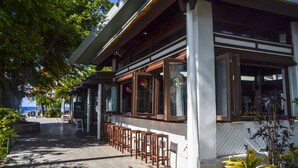 A coastal building with a wooden deck, large windows, and outdoor seating. - Nakelo Treasure Island Resort & Spa (Treasure Island)