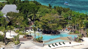 A resort with a large pool surrounded by palm trees and a beach area. - Nakelo Treasure Island Resort & Spa (Treasure Island)