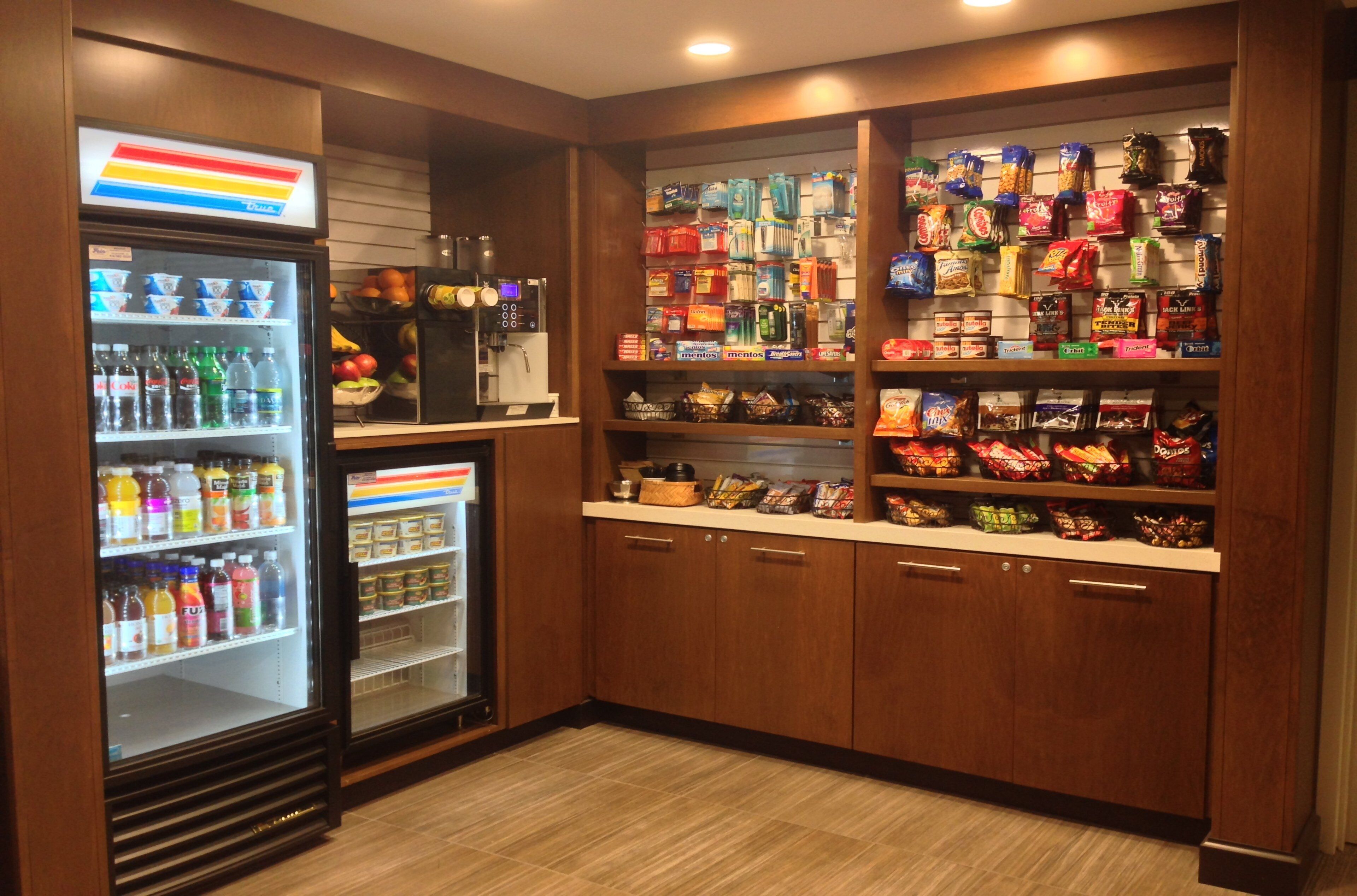 Zona de venta automática con aperitivos y bebidas, que incluye varios productos y un dispensador de bebidas.