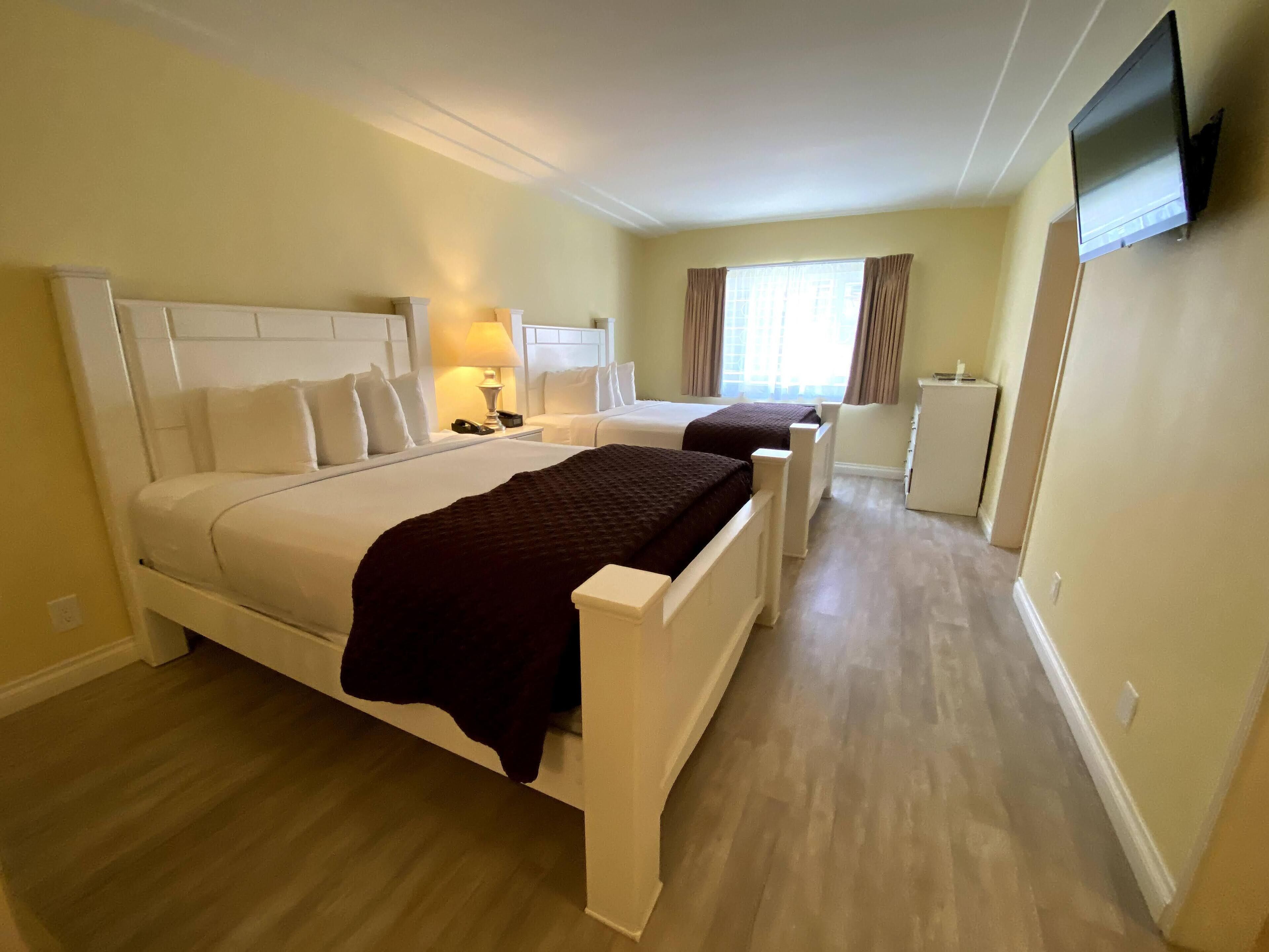 executive room, 2 queen beds, kitchen | blackout curtains, iron/ironing board, free cots/infant beds