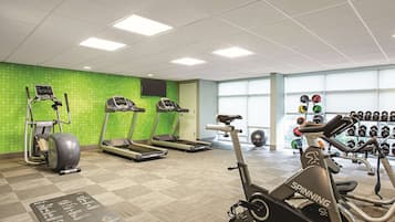 A gym with treadmills, an elliptical, and a stationary bike.