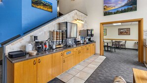 A modern kitchen with granite countertops, stainless steel appliances, and a view of a dining area.