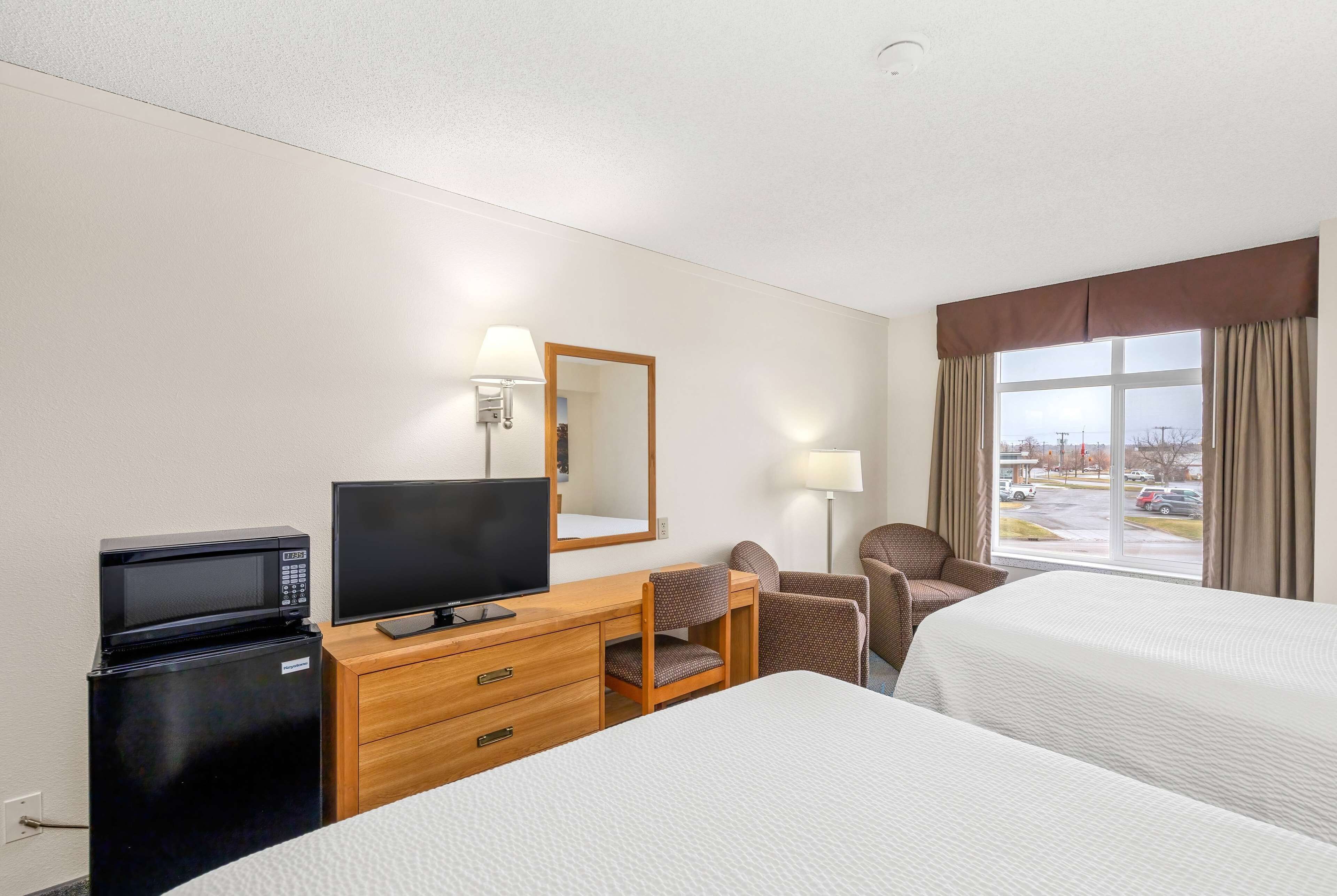 deluxe room, 2 queen beds, non smoking | in-room safe, desk, soundproofing, iron/ironing board