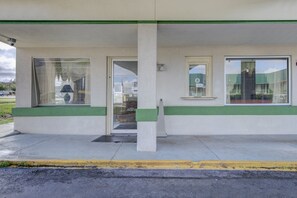 A building with a green and white facade, large windows, and a visible entrance. - Rise Inn by OYO US 441 (Douglas)