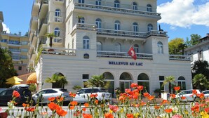 Un hotel de varios pisos con balcones y un letrero que dice 'HOTEL BELLEVUE'.