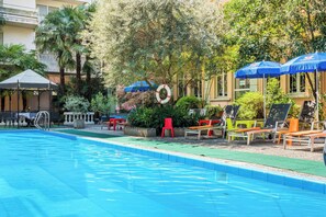 Seasonal outdoor pool, open 10:00 AM to 9:00 PM, pool umbrellas