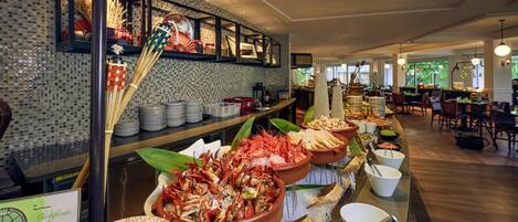 A buffet area with seafood dishes, a certificate display, and a sign reading 'JOO CHIAT'.