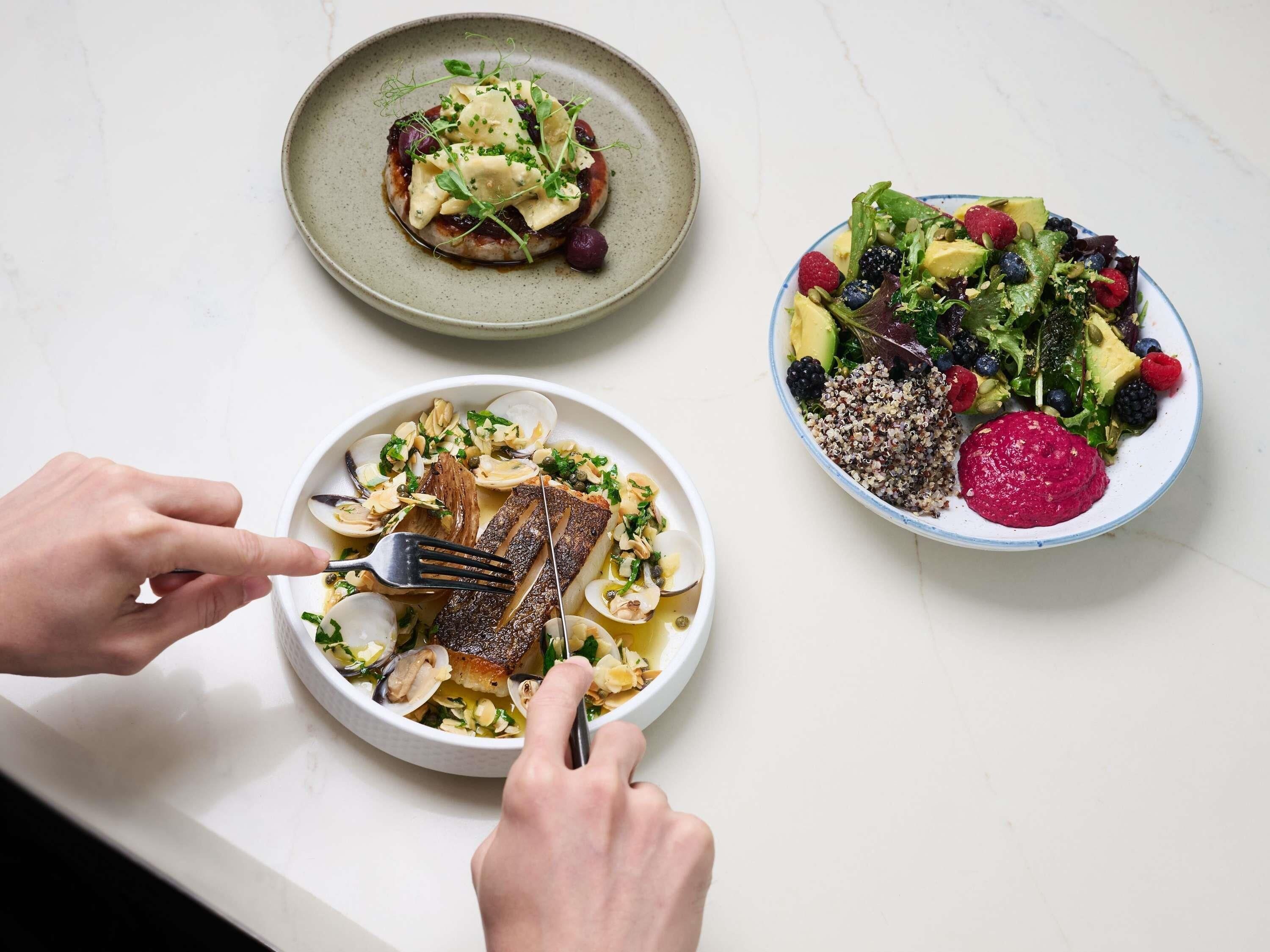 Three plates of food on a table.