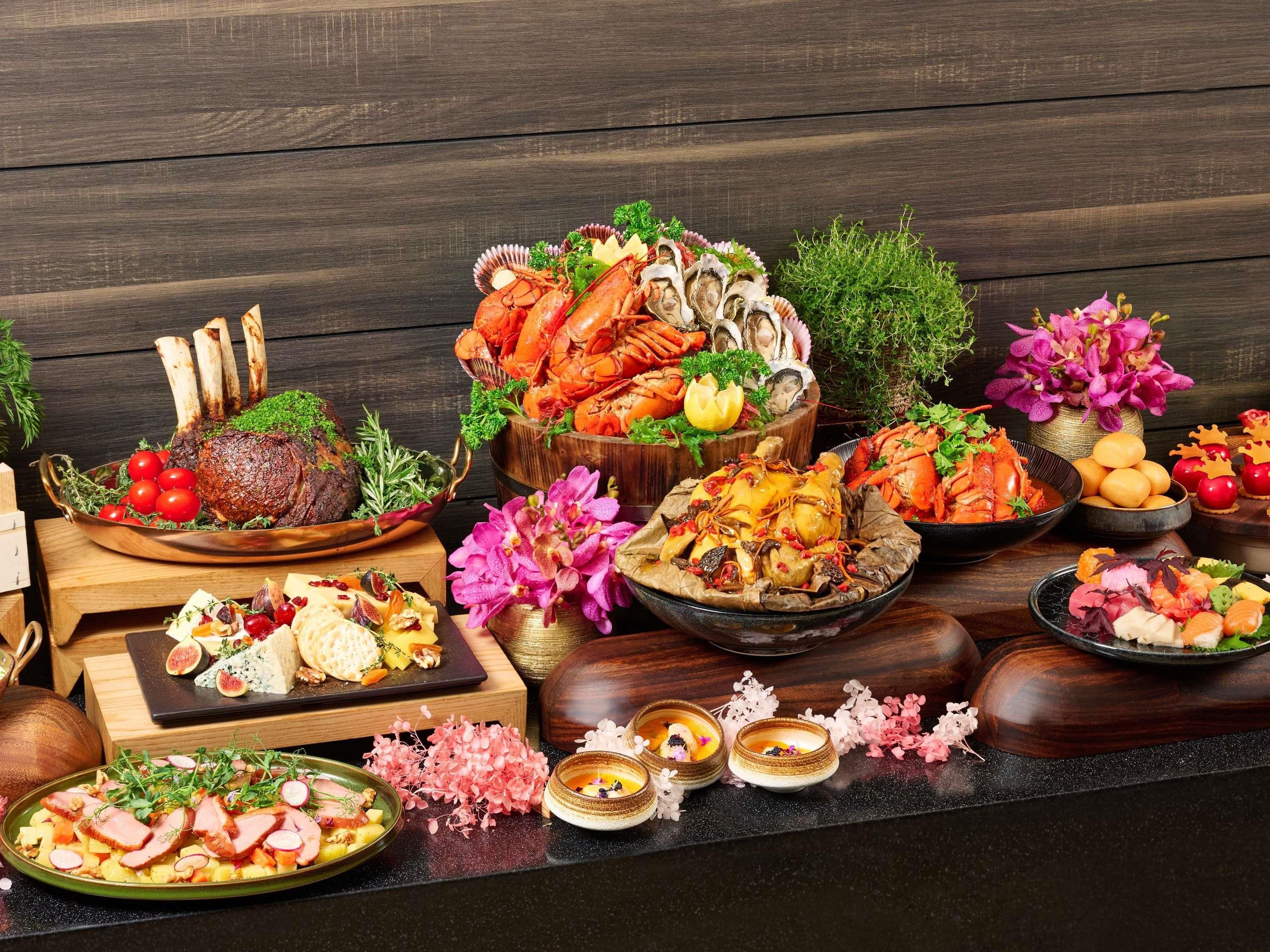 A variety of dishes and food items displayed on a wooden table.