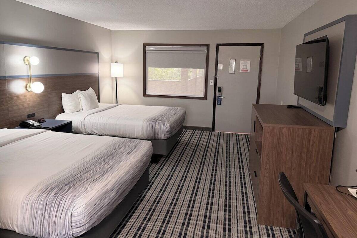 Premium bedding, pillow-top beds, laptop workspace, blackout curtains