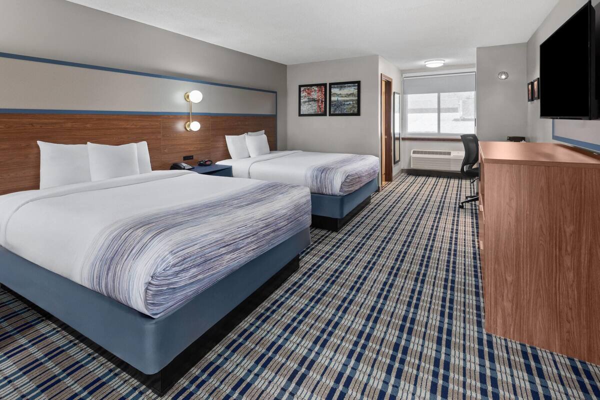 Premium bedding, pillowtop beds, laptop workspace, blackout drapes