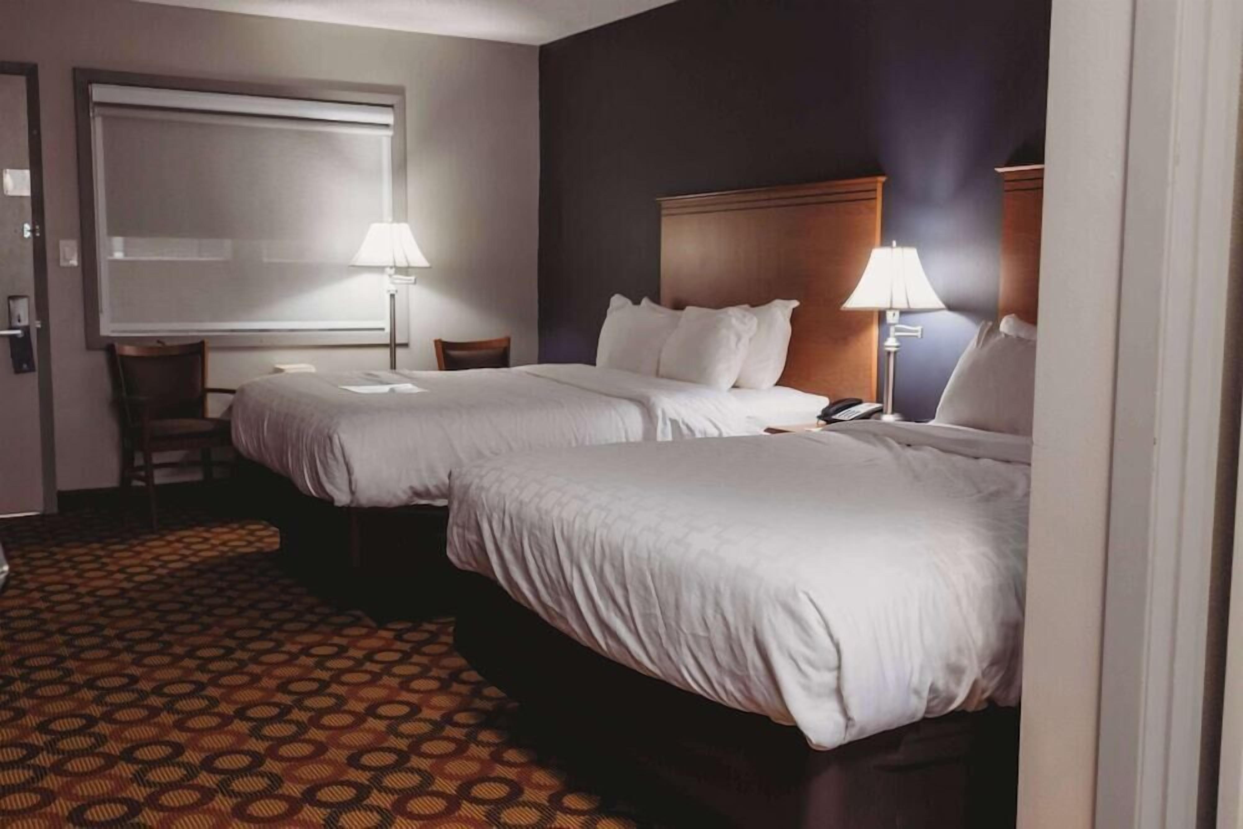 Premium bedding, pillow-top beds, laptop workspace, blackout curtains