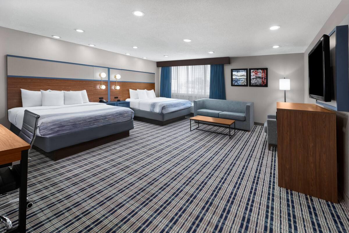Premium bedding, pillowtop beds, laptop workspace, blackout drapes