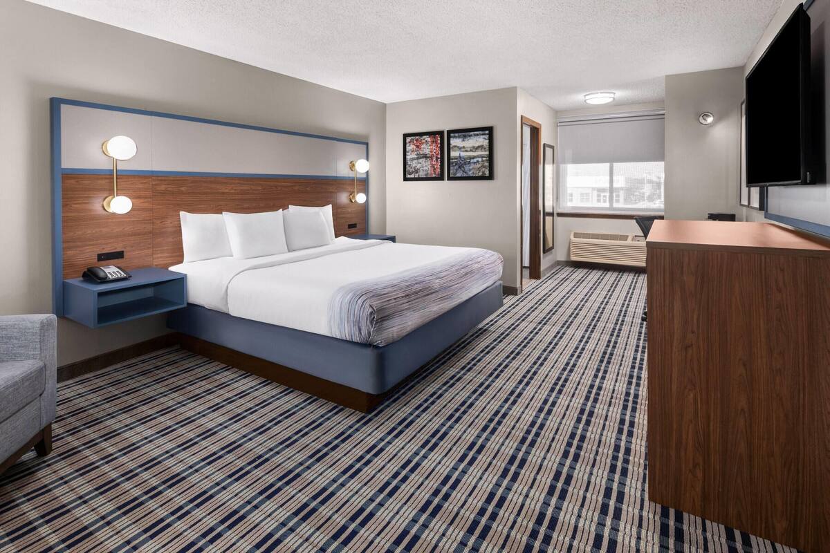 Premium bedding, pillowtop beds, laptop workspace, blackout drapes