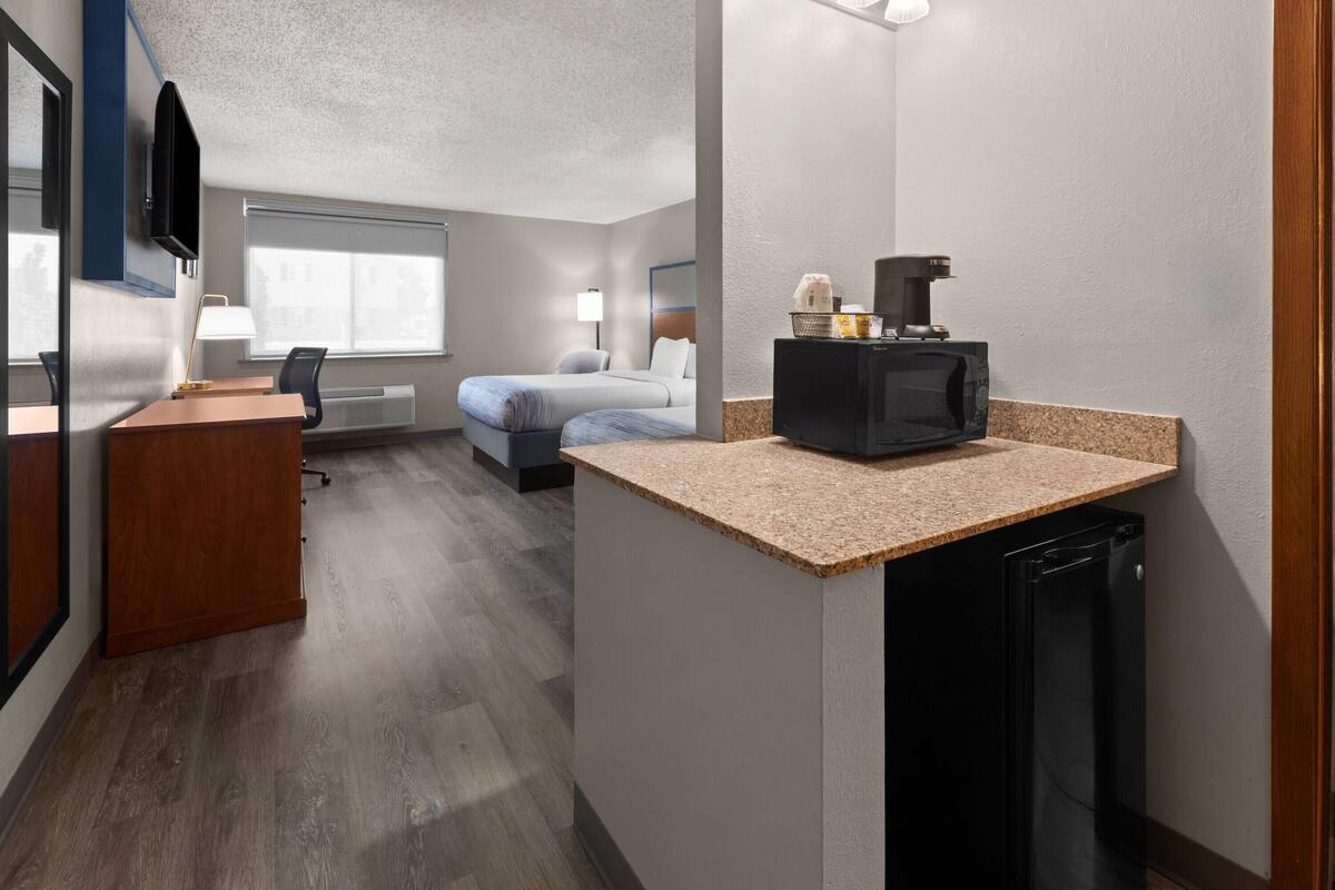 Premium bedding, pillowtop beds, laptop workspace, blackout drapes