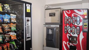 A vending machine with snacks and a Coca-Cola machine with ice cubes. - Red Roof Inn Philadelphia - Oxford Valley (Langhorne)