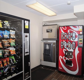 A vending machine with snacks and a Coca-Cola machine with ice cubes. - Red Roof Inn Philadelphia - Oxford Valley (Langhorne)