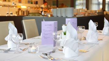 A table set for a meal with a menu, candles, and white napkins.
