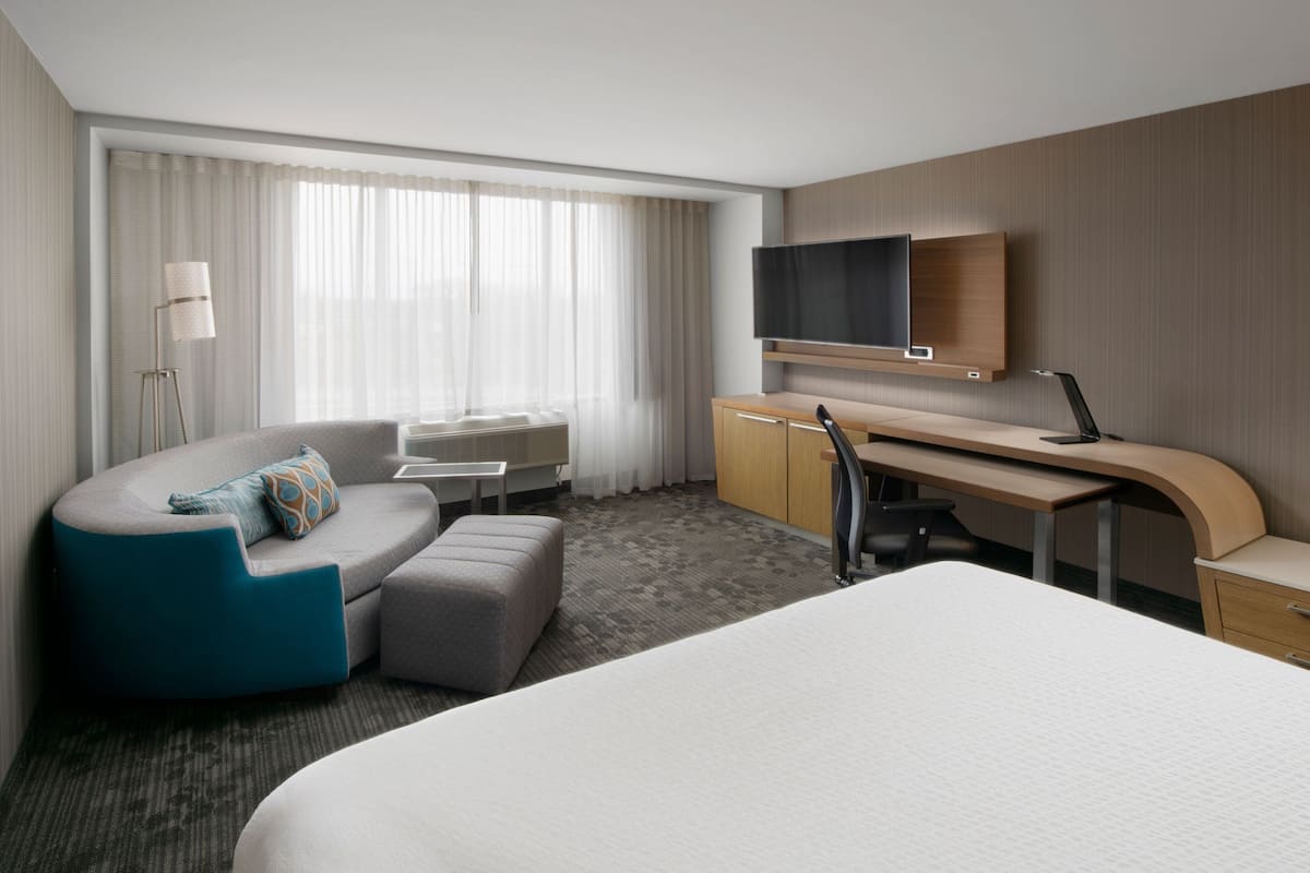 Premium bedding, desk, laptop workspace, iron/ironing board