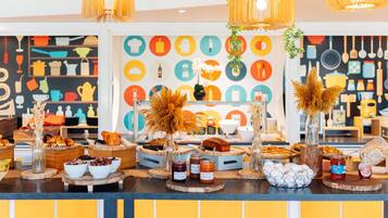 A buffet setup with various food items and decorative elements.