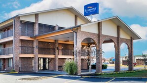 A Baymont Inn & Suites with a brick facade, multiple balconies, and a covered entrance. - Baymont by Wyndham Goodlettsville/Nashville (Goodlettsville)
