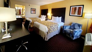A hotel room with two beds, a desk, a chair, a lamp, and a picture on the wall. - Baymont by Wyndham Goodlettsville/Nashville (Goodlettsville)