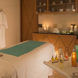 Experience a calm and inviting space with a neatly made bed, robe, and relaxing amenities.