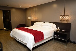 A modern hotel room with a large bed, two bedside tables, and a red throw blanket. - Hotel Le Rêve Pasadena (Pasadena)