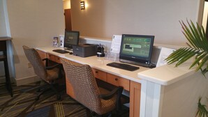 A hotel workspace with two computers, a printer, and two office chairs. - Holiday Inn Express - Harrisburg East by IHG (Harrisburg)
