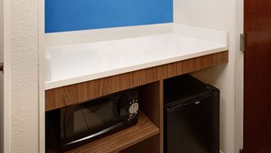 A kitchen with a microwave and a black refrigerator. - Holiday Inn Express - Harrisburg East by IHG (Harrisburg)