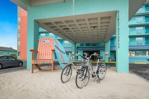 A building with a sign reading "610 West Beach Blvd." and a covered area with bicycles parked. - Beachside Resort Hotel (Gulf Shores)