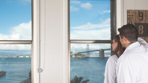 A room with large windows overlooking a bridge and a body of water. - Harbor Court Hotel (San Francisco)