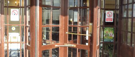 A corner door with glass panels and a checkered floor.