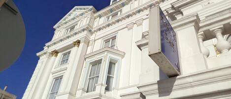 A white building with classical architecture, including columns and decorative moldings.