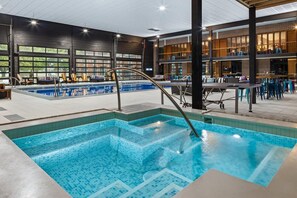 Relax by the pool surrounded by lounge chairs and tables.