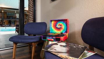 Relax in a stylish room with a seating area, featuring two comfortable chairs and a small table.