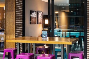 Enjoy a meal at this stylish table, set in front of a glass partition with a view of the outside.