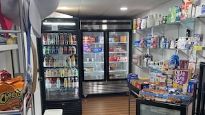 A small convenience store with refrigerated sections, snack aisles, and a seating area. - Travelodge by Wyndham Vernon CT (Vernon)